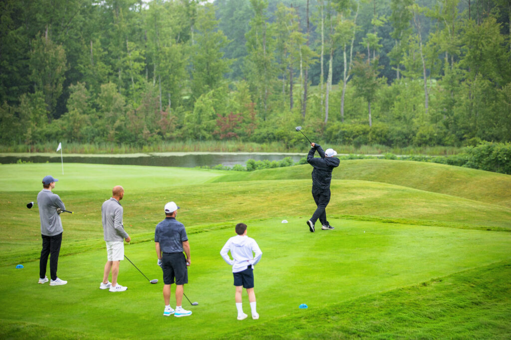 Group of golfers at a tee during an outing at The Oaks