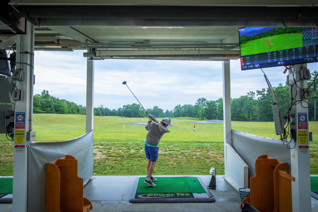Golfer practicing in a Toptracer bay at The Oaks